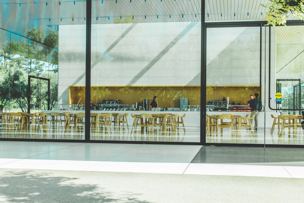Contemporary café with glass walls showcasing a sleek interior design in Cupertino, California.